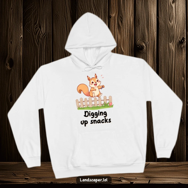 Funny hoodie featuring a happy squirrel energetically leaping over a garden fence with a tiny shovel. Cozy and full of life.