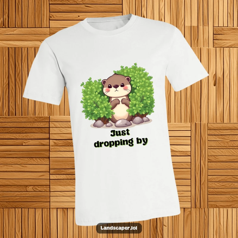 Funny t-shirt with a curious otter peeking from behind a lush bush, dropping a shiny pebble with a playful expression. Cute and funny.